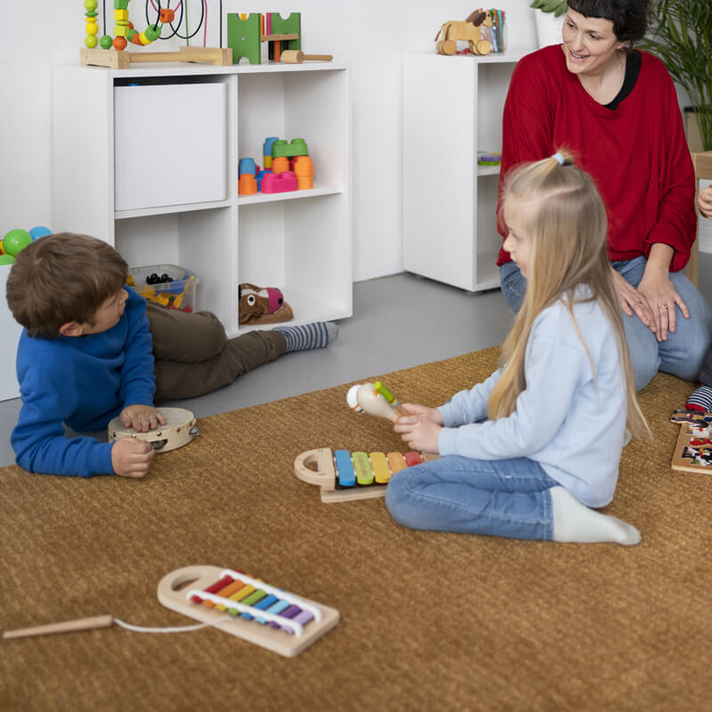 full-shot-teacher-watching-kids-learn (1)